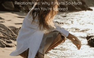 Woman in a white shirt crouches on a sandy beach near the water, with a text overlay exploring needs vs expectations in relationships.